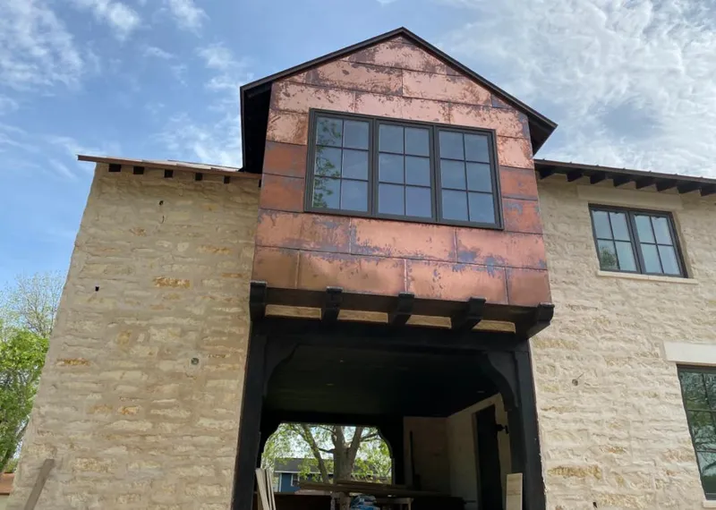 Copper metal panel facade on a stone building for Skylight Installation in Destin