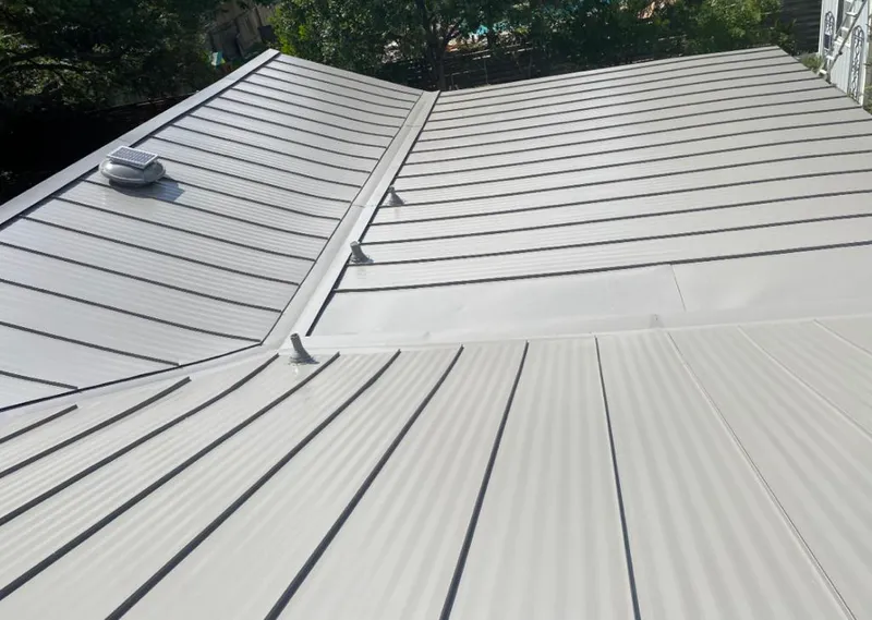 Solar attic fan installed on a metal roof for Roof Ventilation in Destin